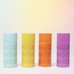 Load image into Gallery viewer, Nöz reef-safe sunscreen sticks in blue, yellow, orange, and purple.
