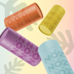 Load image into Gallery viewer, An artsy view of Nöz reef-safe sunscreen sticks in blue, yellow, orange, and purple.
